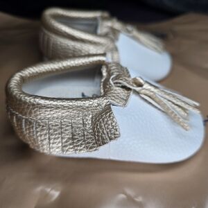 NWOT Infant/Baby Moccasin Shoes - 0-6 Months-White with Gold Tassels/Fringe.